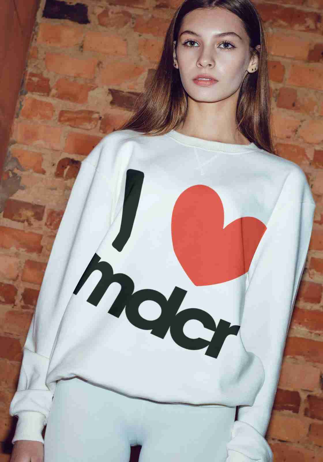 I love mdcr - campaign sweatshirt against a Manchester brick wall
